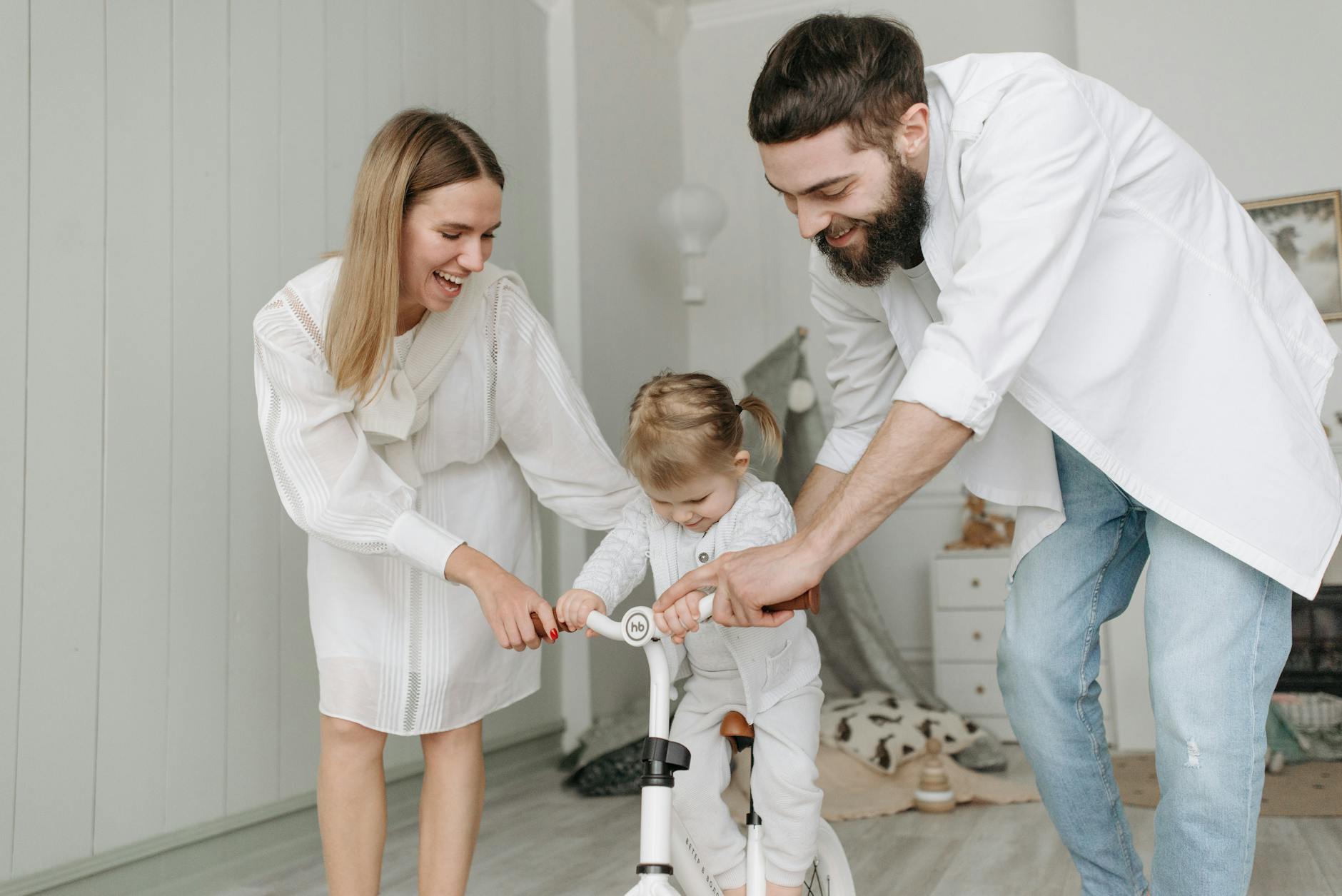 parents teaching their child on riding a bike